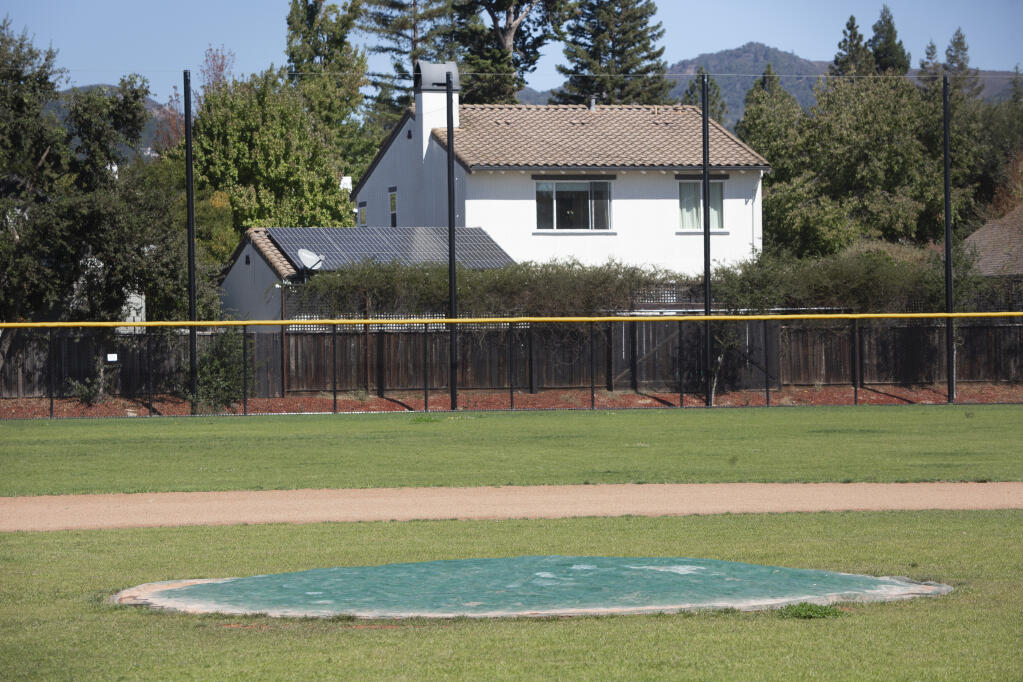 A Sonoma Valley High School baseball field pitcher’s mound in the playing field that borders housing, on Monday, Sept. 26, 2022. The vertical poles hold up netting meant to catch stray balls. (Robbi Pengelly/Index-Tribune)
