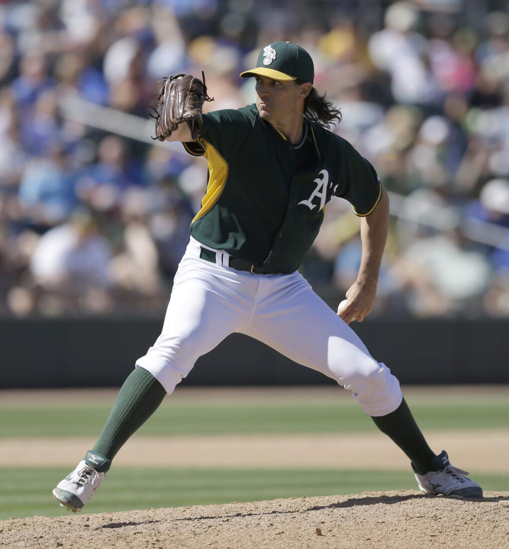 In this file photo from March 24, 2015, Oakland Athletics' Barry Zito works against the Chicago Cubs in the fourth inning of a spring training exhibition baseball game in Mesa, Ariz. The Oakland As on Wednesday, Sept. 16, 2015, selected Zito from Triple-A Nashville, who will join the team in Chicago. (AP Photo/Ben Margot)
