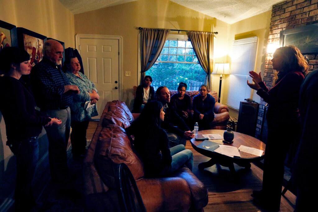 Ronit Rubinoff, right, executive director of Legal Aid of Sonoma County, talks with a group of tenants being evicted from a block of rental houses off Todd Road in Santa Rosa, California on Thursday, April 14, 2016. (Alvin Jornada / The Press Democrat)