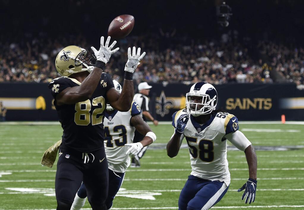 New Orleans Saints tight end Benjamin Watson (82) pulls in a touchdown pass in front of Los Angeles Rams strong safety John Johnson (43) and inside linebacker Cory Littleton (58) in the first half of an NFL football game in New Orleans, Sunday, Nov. 4, 2018. (AP Photo/Bill Feig)