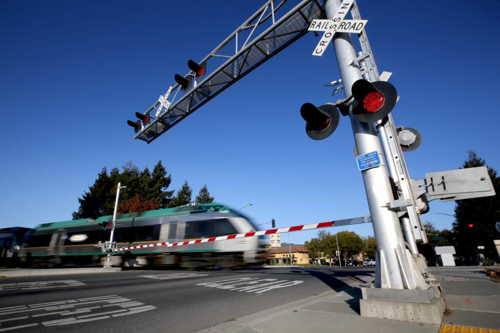 The SMART train passes through the crossing at Golf Course Drive in Rohnert Park, California on Thursday, November 21, 2019. (BETH SCHLANKER/The Press Democrat)