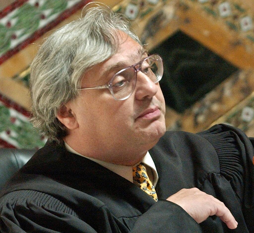 FILE - In this Sept. 22, 2003, file photo, Judge Alex Kozinski, of the 9th U.S. Circuit Court of Appeals, gestures in San Francisco. Kozinski announced his immediate retirement Monday, Dec. 18, 2017, days after women alleged he subjected them to inappropriate sexual conduct or comments. Kozinski said in a statement Monday that a battle over the accusations would not be good for the judiciary. (AP Photo/Paul Sakuma, Pool, File)