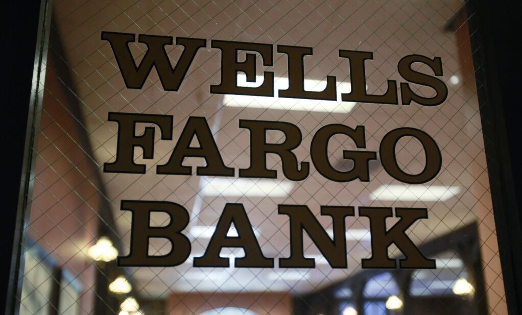 FILE - This April 19, 2010, file photo, shows a Wells Fargo Bank in Palo Alto, Calif. Wells Fargo employees, both current and former, say working at the nation's second-largest financial institution meant a constant and compulsive pressure to sell. Then, for some, came stress-induced health problems. The employees said they were trying to sell enough bank products just to keep their jobs. (AP Photo/Paul Sakuma, File)