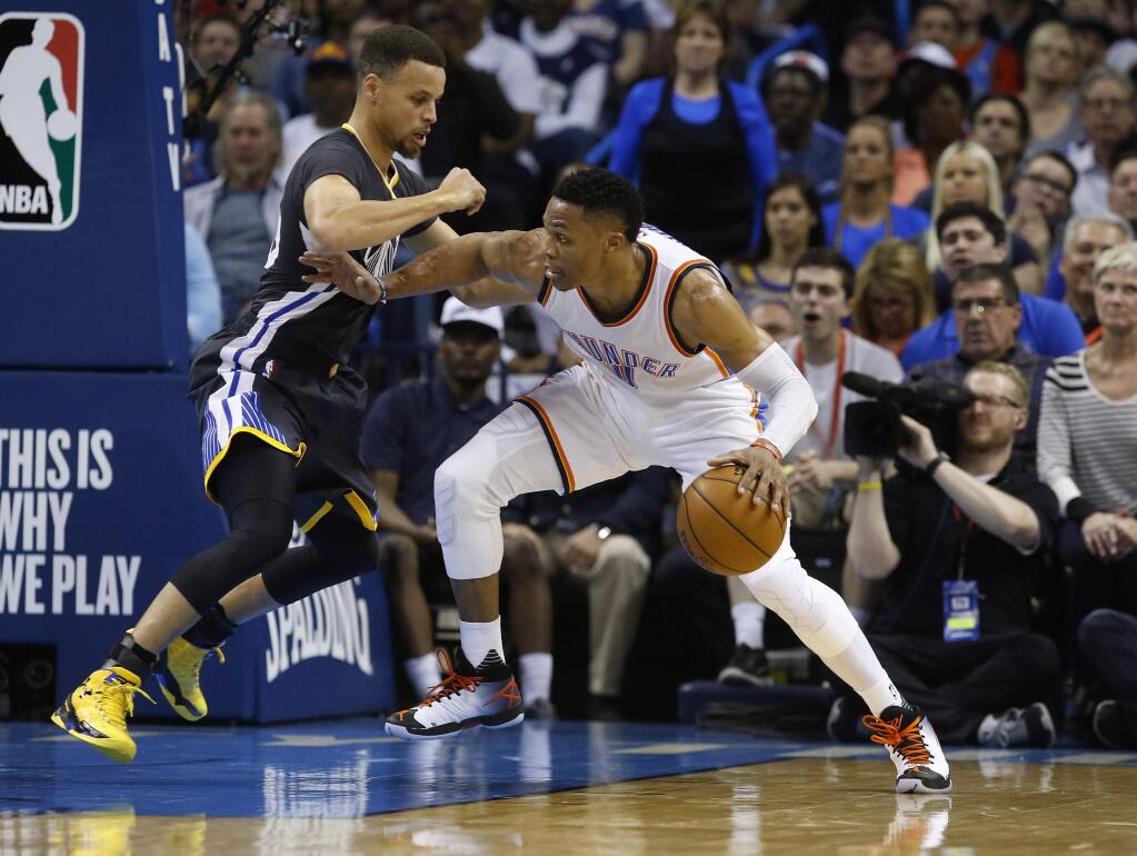 Oklahoma City Thunder guard Russell Westbrook, right, drives against Golden State Warriors guard Stephen Curry during the second quarter Saturday, Feb. 27, 2016. (AP Photo/Sue Ogrocki)