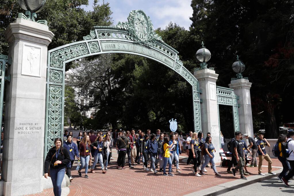 FILE - In this Aug. 15, 2017 file photo, students walk on the University of California, Berkeley campus in Berkeley, Calif. California community college students will be guaranteed admission into the University of California if they meet certain course requirements. University of California and the California Community Colleges agreed Wednesday, April 11, 2018, that students who do well in courses that UC faculty helped develop will win admission into a UC campus. (AP Photo/Marcio Jose Sanchez, File)