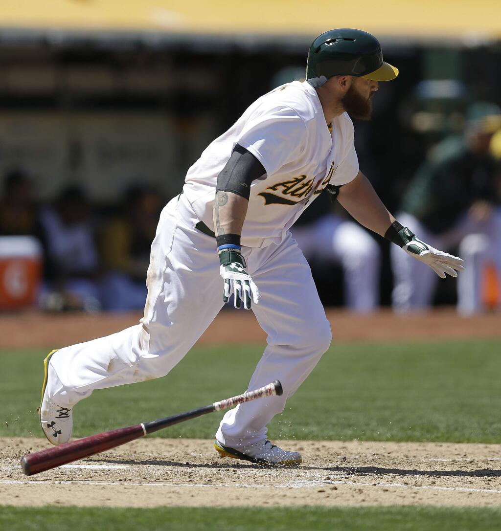 Oakland Athletics' Jonny Gomes drops his bat after hitting a three run triple off Kansas City Royals' Aaron Crow in the fifth inning of a baseball game Saturday, Aug. 2, 2014, in Oakland. (AP Photo/Ben Margot)