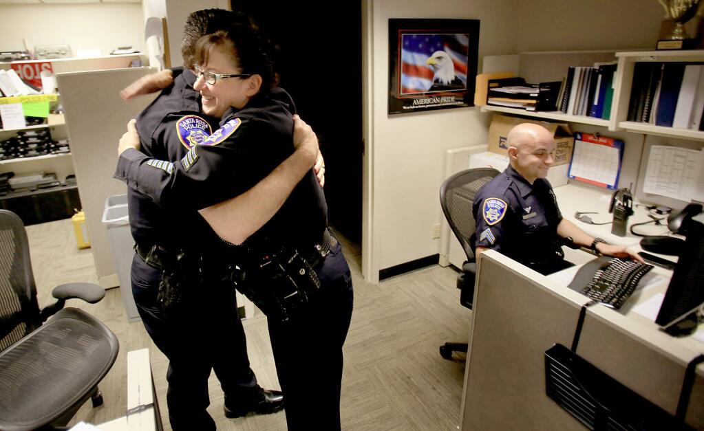 On her last day of patrol at the Santa Rosa Police Department, Lisa Banayat is greeted by colleague Sgt. Jon Wolf, Wednesday July 22, 2015 in Santa Rosa. (Kent Porter / Press Democrat) 2015