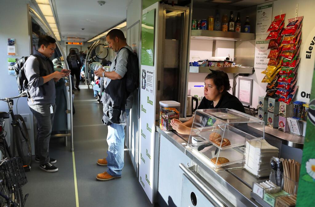 Shanicea Peterson waits for a customer at the Buzz concession service onboard a northbound SMART train on Monday afternoon, March 26, 2018. (Christopher Chung/ The Press Democrat)
