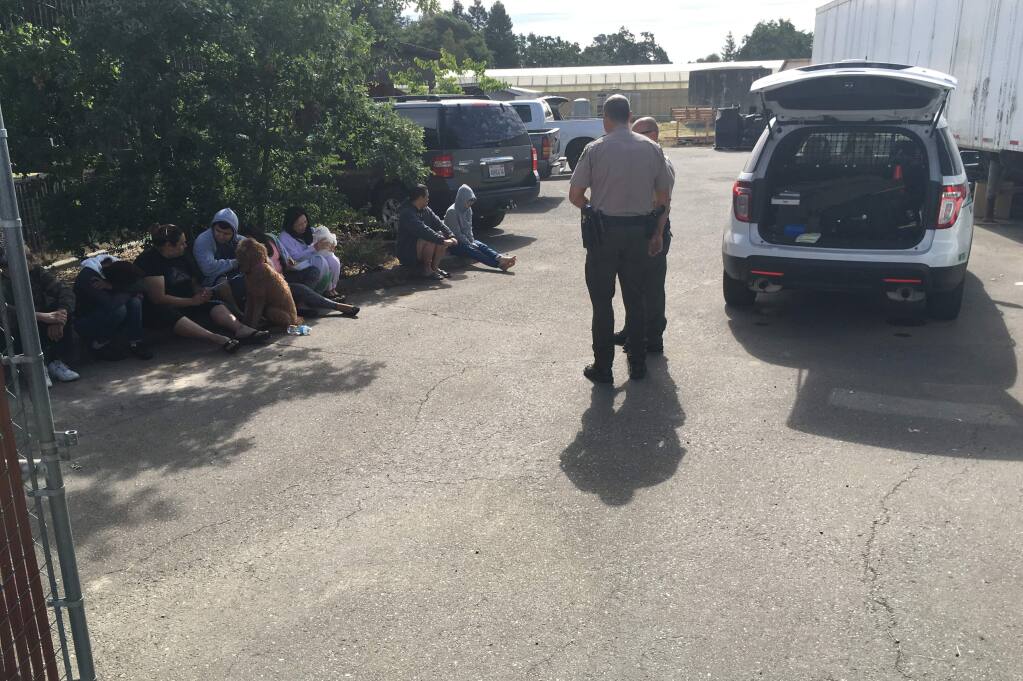 People were detained outside a rural Irwin Lane property in west Santa Rosa after a raid targeting cannabis oil labs on Wednesday, June 15, 2016. (JULIE JOHNSON/ PD)