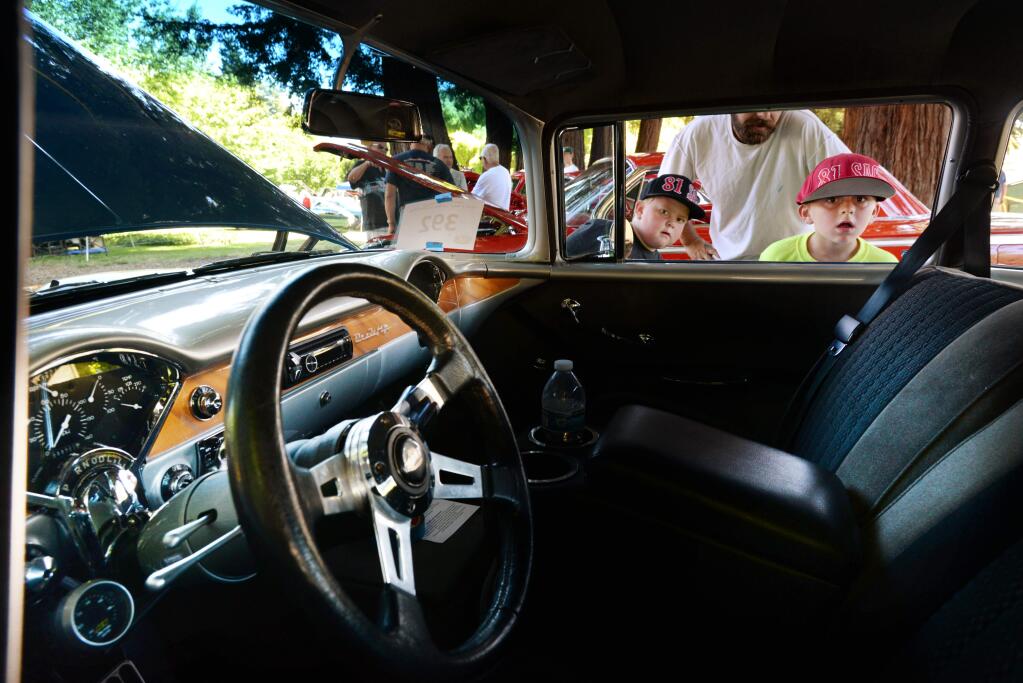 Austin Blystone, center in white T-shirt, out with his sons Austin, 8, left, and Robert, 6, while looking at the interior of a 1955 Chevy during Father's Day 'Show & Shine” Car Show held Sunday at Juilliard Park in Santa Rosa. June 18, 2017.(Photo: Erik Castro/for The Press Democrat)