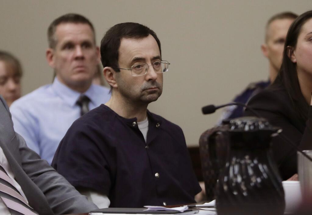 Larry Nassar sits during his sentencing hearing Wednesday, Jan. 24, 2018, in Lansing, Mich. The former sports doctor who admitted molesting some of the nation's top gymnasts for years was sentenced Wednesday to 40 to 175 years in prison as the judge declared: 'I just signed your death warrant.' The sentence capped a remarkable seven-day hearing in which scores of Nassar's victims were able to confront him face to face in the Michigan courtroom. (AP Photo/Carlos Osorio)