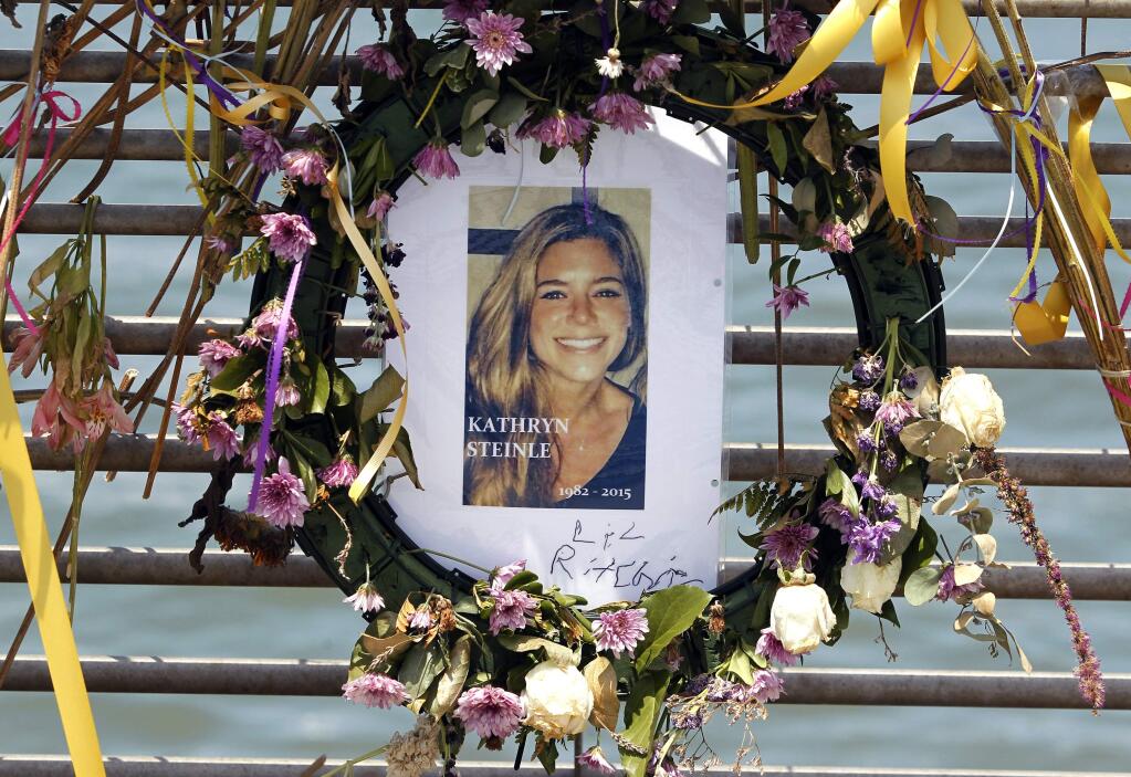 FILE - This July 17, 2015, file photo shows flowers and a portrait of Kate Steinle displayed at a memorial site on Pier 14 in San Francisco, Calif. The bullet that killed Kate Steinle two years ago ricocheted off the ground about 100 yards away before hitting her in the back and later launching a criminal case at the center of a national immigration debate. A San Francisco police officer who helped supervise the investigation testified about the bullet's trajectory Monday, Oct. 30, 2017 at Zarate's trial. (Paul Chinn /San Francisco Chronicle via AP, File)