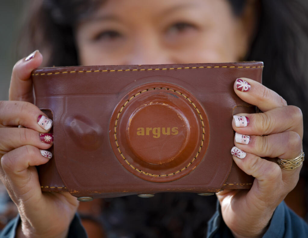 Petaluma Argus-Courier staff photographer Crissy Pascual holds an antique camera called the argus that she found at a downtown thrift store. (COURTESY OF JENNIFER MORSE)
