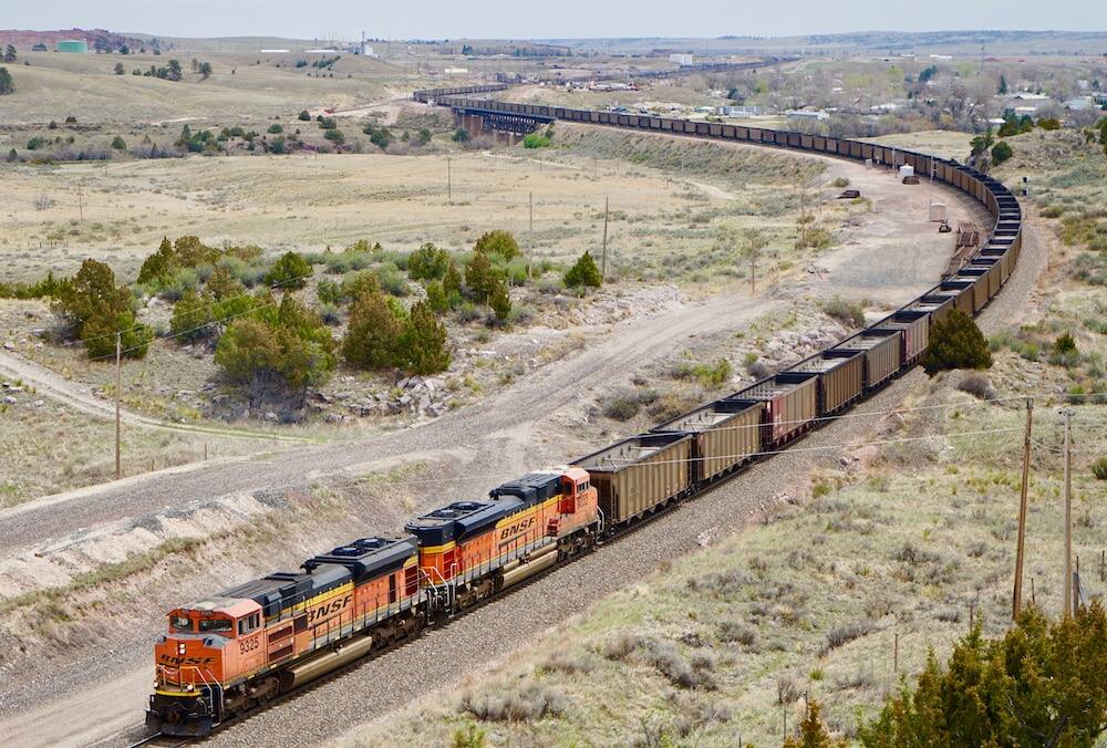 An empty coal train stretches nearly as far as the eye can see as it leaves Guernsey, Wyoming in the spring of 2020 and heads back to mines in the Powder River Basin for another load. North Bay officials fear the prospect of such trains, often as much as a hundred cars long, traveling through the area for coal export out of Humboldt Bay. (Andrew Graham / WyoFile)