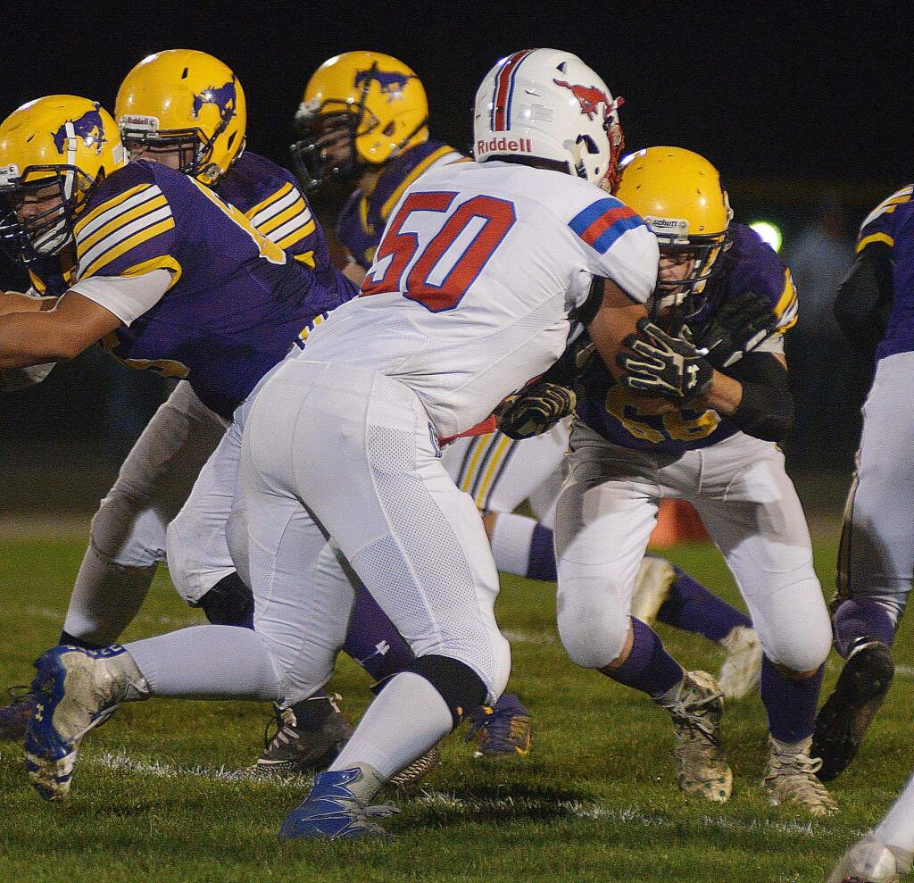 SUMNER FOWLER/FOR THE ARGUS-COURIERSt. Vincent's Giovanni Vaca battles with Middletown's Blake Schuster in the trenches during NCS playoff game won by Middletown.