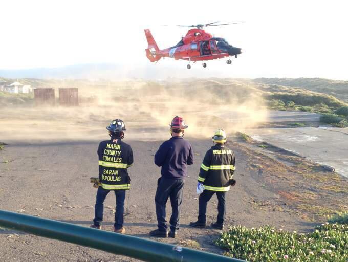 A Coast Guard helicopter rescued one kayaker from the rocky shoreline of Tomales Bay on Wednesday and recovered the body of another from the water.