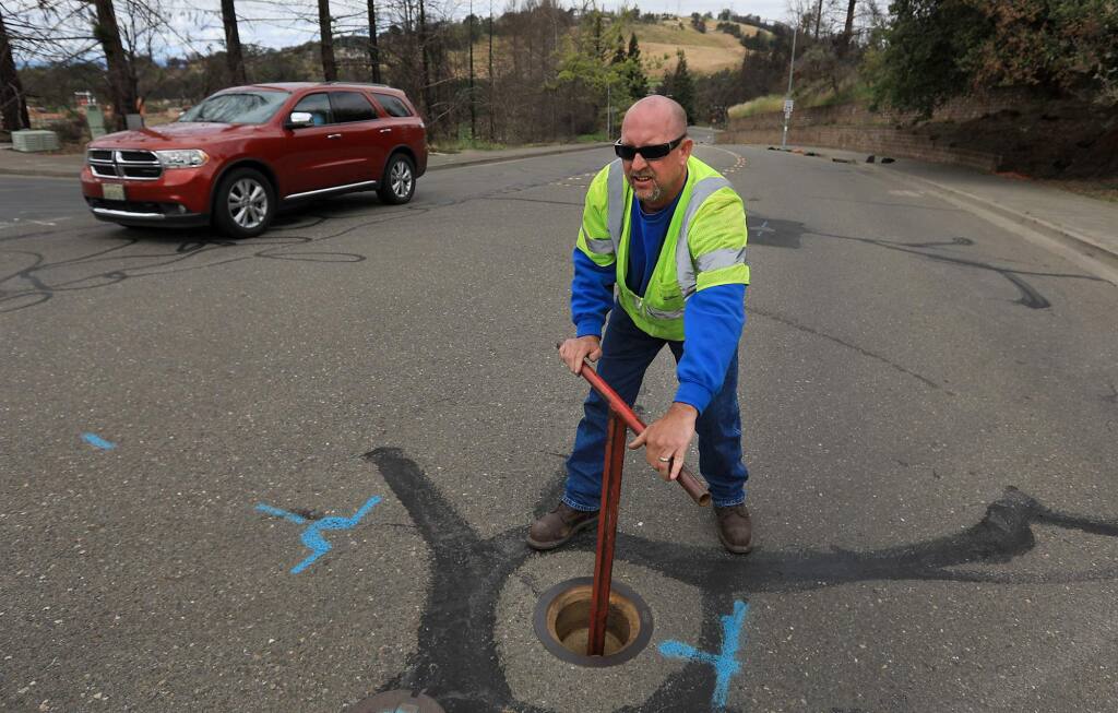 Anthony Drolet, a utility systems operators with the City of Santa Rosa, turns a valve to let water flow to a fire hydrant used to flush a water line in the Foutaingrove area of Santa Rosa, Wednesday, May 16, 2018, (Kent Porter / The Press Democrat) 2018
