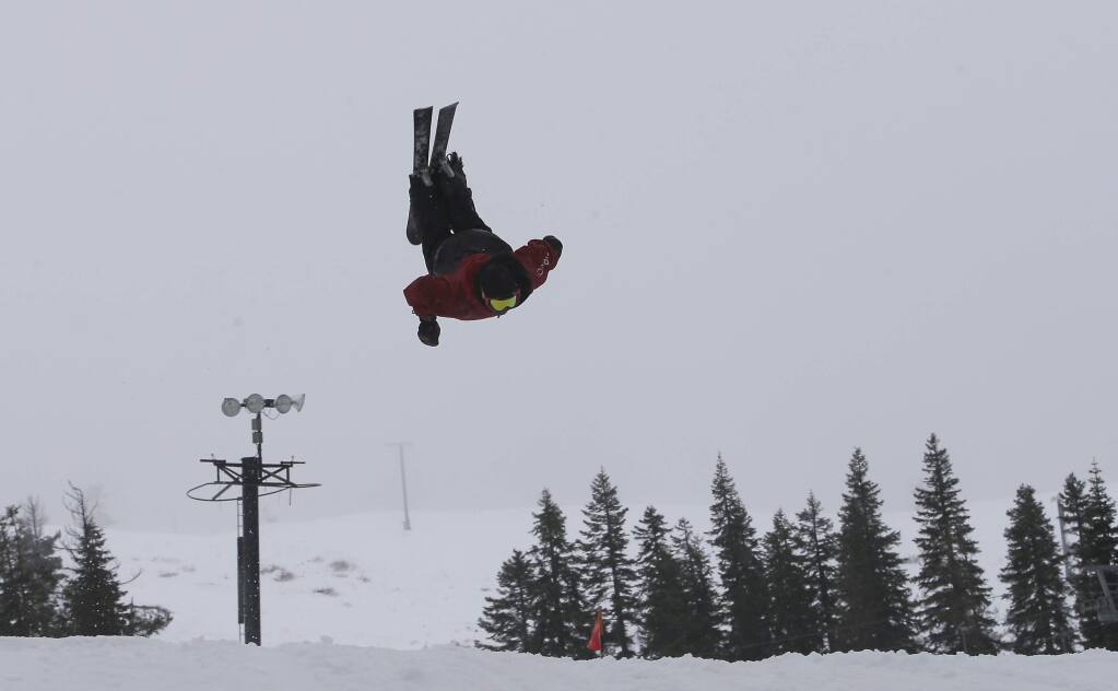A skier performs a backflip off a jump at the Boreal Mountain Ski Resort near Donner Summit, Calif., Thursday, Dec. 4, 2014. A storm that swept over California Wednesday dropped nearly a foot of snow on Donner Summit with another storm to arrive Friday.(AP Photo/Rich Pedroncelli)
