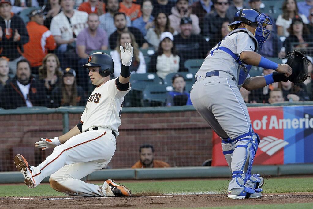 San Francisco Giants' Buster Posey, left, scores past Kansas City Royals catcher Salvador Perez during the second inning of a baseball game in San Francisco, Tuesday, June 13, 2017. (AP Photo/Jeff Chiu)