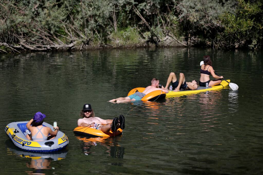 A group of friends float on the Russian River at Steelhead Beach near Forestville on Sunday, September 15, 2019. (BETH SCHLANKER/ The Press Democrat)