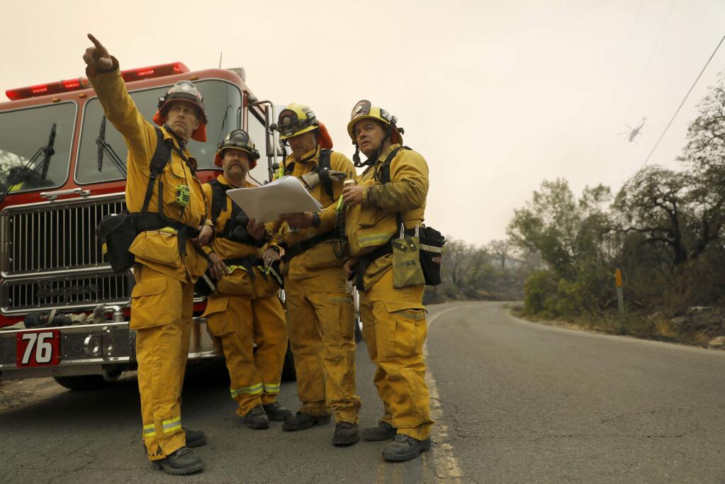 Fire fighters from Vernon, Calif., look for the Norbbom Fire but can only find Norrbom Rd., as they assess fires in Sonoma Valley in October 12, 2017. (BETH SCHLANKER/The Press Democrat)