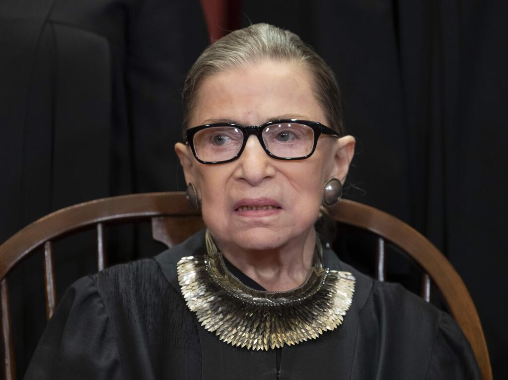 FILE - In this Nov. 30, 2018 file photo, Associate Justice Ruth Bader Ginsburg sits with fellow Supreme Court justices for a group portrait at the Supreme Court Building in Washington. The Supreme Court announced Aug. 23, 2019, that Ginsburg has been treated for a malignant tumor. (AP Photo/J. Scott Applewhite, File)