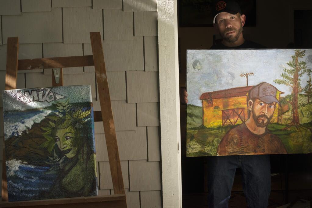 Artist and musician Jase Casabella who does 'live drawing' at local concerts holding a self portrait oil painting at his home studio in Santa Rosa. May 17, 2017. (Photo: Erik Castro/for The Press Democrat)