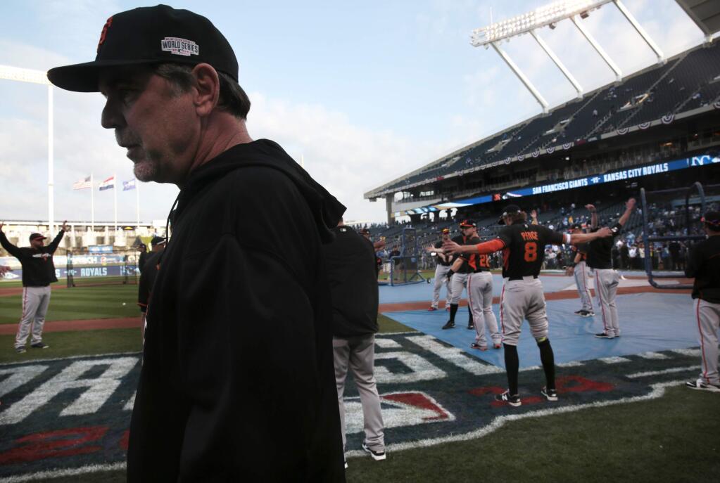 San Francisco Giants manager Bruce Bochy stands by as players warm up before the start of Game 2 of the World Series at Kauffman Stadium on Wednesday, October 22, 2014 near Kansas City, Missouri. (BETH SCHLANKER/ The Press Democrat)