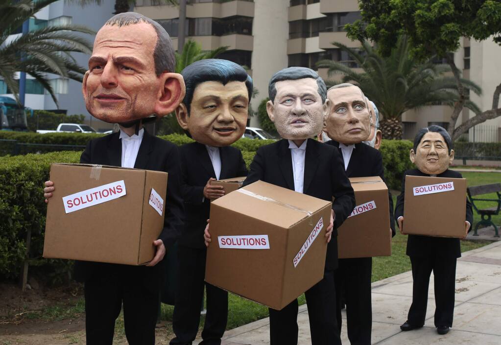 MARTIN MEJIA / Associated PressEnvironmental activists perform representing leaders, from left, Australia's Prime Minister Tony Abbott, China's President Xi Jinping, Canada's Prime Minister Stephen Harper, Russia's President Vladimir Putin and Japan's Prime Minister Shinzo Abe during the climate change conference in Lima Peru.