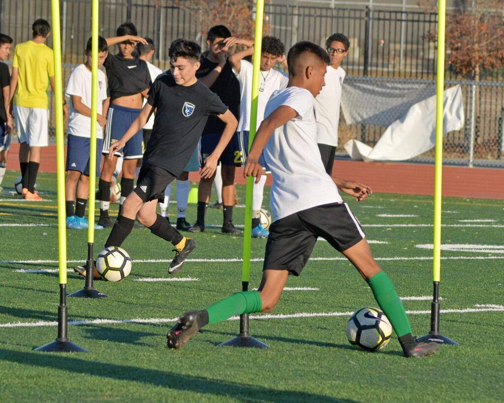 SUMNER FOWLER/FOR THE ARGUS-COURIERCasa Grande soccer players work out under the watchful eye of new coaches Joran Schlau and Kevin Richardson in tryouts this week.