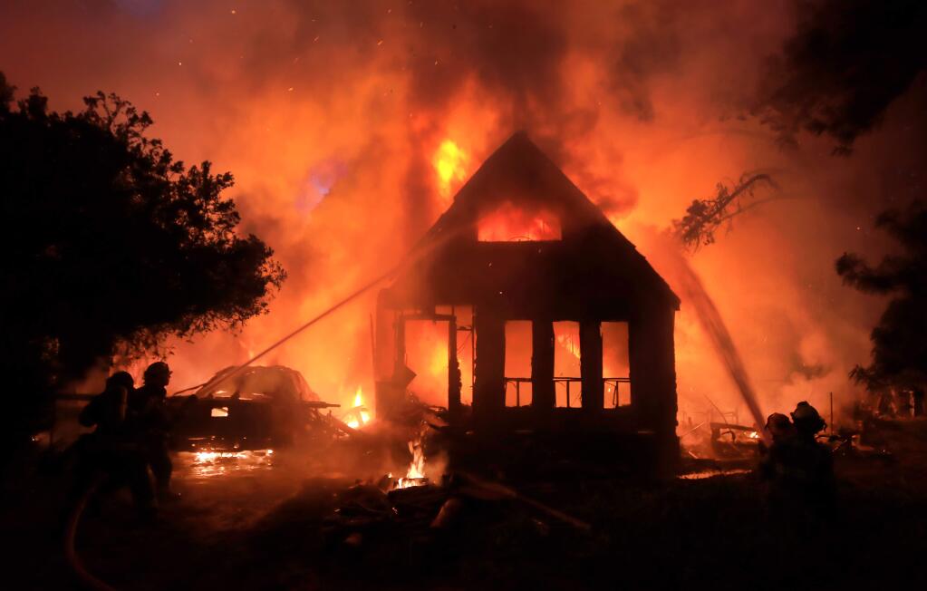 Occidental firefighters move back to a defensive stance to keep flames from spreading to surrounding vegetation as flames devour a home on Occidental Road near Furlong Road on Tuesday, Oct. 2, 2019. (KENT PORTER/ PD)