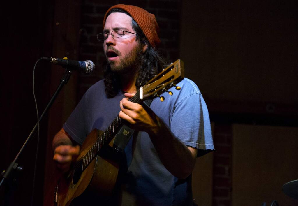 Singer-songwriter Charlie Davenport plays his original song “Tilted Shrine” at the Arlene Francis Center on Friday during a benefit concert to support victims of the Ghost Ship warehouse fire in Oakland. (Estefany Gonzalez/For The Press Democrat)