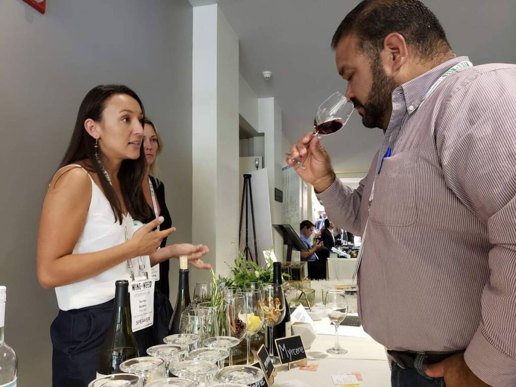 Devika Maskey, founder and CEO of TSO Sonoma speaks to an attendee sampling wine at the North Coast Wine & Weed Symposium on Aug. 2 in Santa Rosa. (Heather Irwin / The Press Democrat)