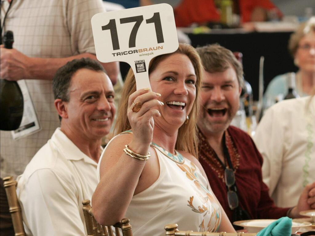 Dawn Lyons of Rohnert Park makes a bid at the 2012 Annual Sonoma Valley Wine Auction. (Scott Manchester / For The Press Democrat)