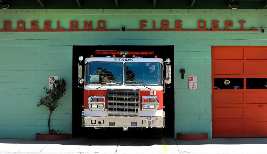 At the Roseland Fire Department, Santa Rosa's station 8, Kevin Fleming pulls the engine out as they prepare for a drill rotation, Tuesday, April 9, 2019. At left is captain Mike Harrison (Kent Porter / Press Democrat) 2019