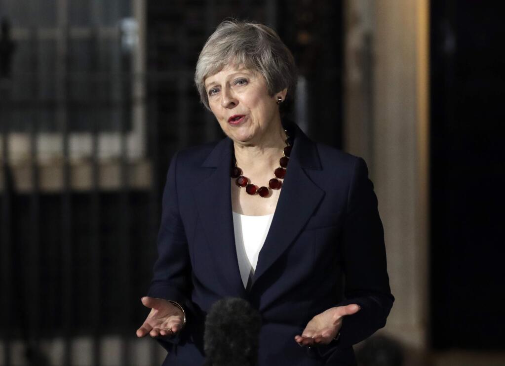 Britain's Prime Minister Theresa May delivers a speech outside 10 Downing Street in London, Wednesday, Nov. 14, 2018. British Prime Minister Theresa May says Cabinet agrees draft Brexit deal with European Union after 'impassioned' debate. (AP Photo/Matt Dunham)