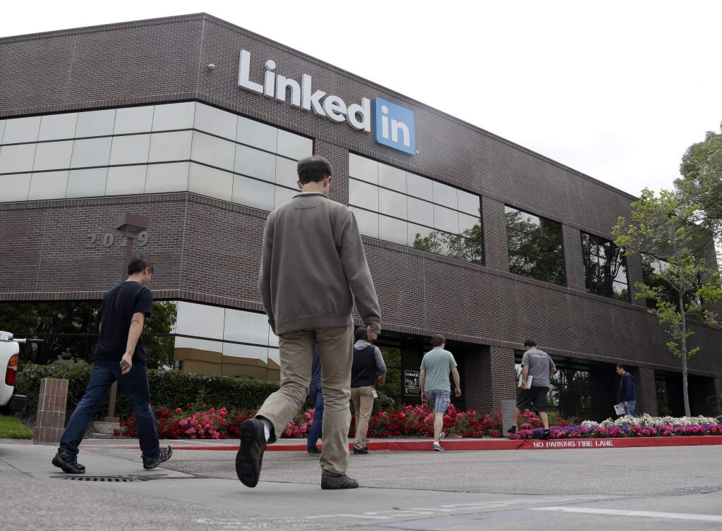 In this May 8, 2014 file photo, people walk outside of LinkedIn headquarters on in Mountain View. (AP Photo/Marcio Jose Sanchez, File)