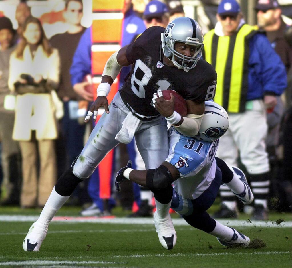Lance Schulters defends on the play.8/4/2004: C1: Raiders wide receiver Tim Brown says he may be relegated to the fourth or fifth receiver spot if he stays in Oakland. 9/24/2004: C6: Receiver Tim Brown, left, will play in Oakland on Sunday night for the first time since being released by the Raiders during training camp. Brown is now a starter for the Tampa Bay Buccaneers.