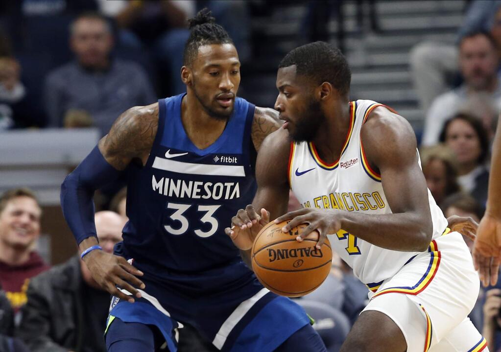 The Golden State Warriors' Eric Paschall, right, drives around against the Minnesota Timberwolves' Robert Covington in the first half Friday, Nov 8, 2019, in Minneapolis. (AP Photo/Jim Mone)