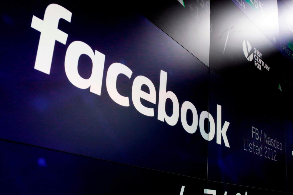 FILE - In this March 29, 2018, file photo, the logo for Facebook appears on screens at the Nasdaq MarketSite in New York's Times Square. For the first time, Facebook is making public, on Tuesday, April 24, its detailed guidelines for determining what it will and won't allow on its service. (AP Photo/Richard Drew, File)