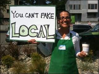A protester, dressed like a Starbucks barrista, pretty much sums it up at the opening of 15th Ave Coffee & Tea.