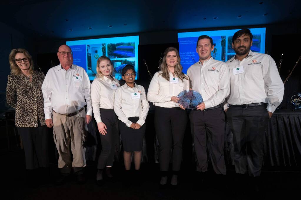 Marybel Batger, Secretary of the California Government Operations Agency, as she presented a GEELA award to the Stone Edge Farms MicroGrid team on Jan. 17, 2018. From left: Batger, Craig Wooster, SEFMG project manager, and current interns Tara Deane, Tejashwee Kandukuri, Rachel Pignata, Ryan Stoltenberg, and Trinath Vernula. (CalEPA)