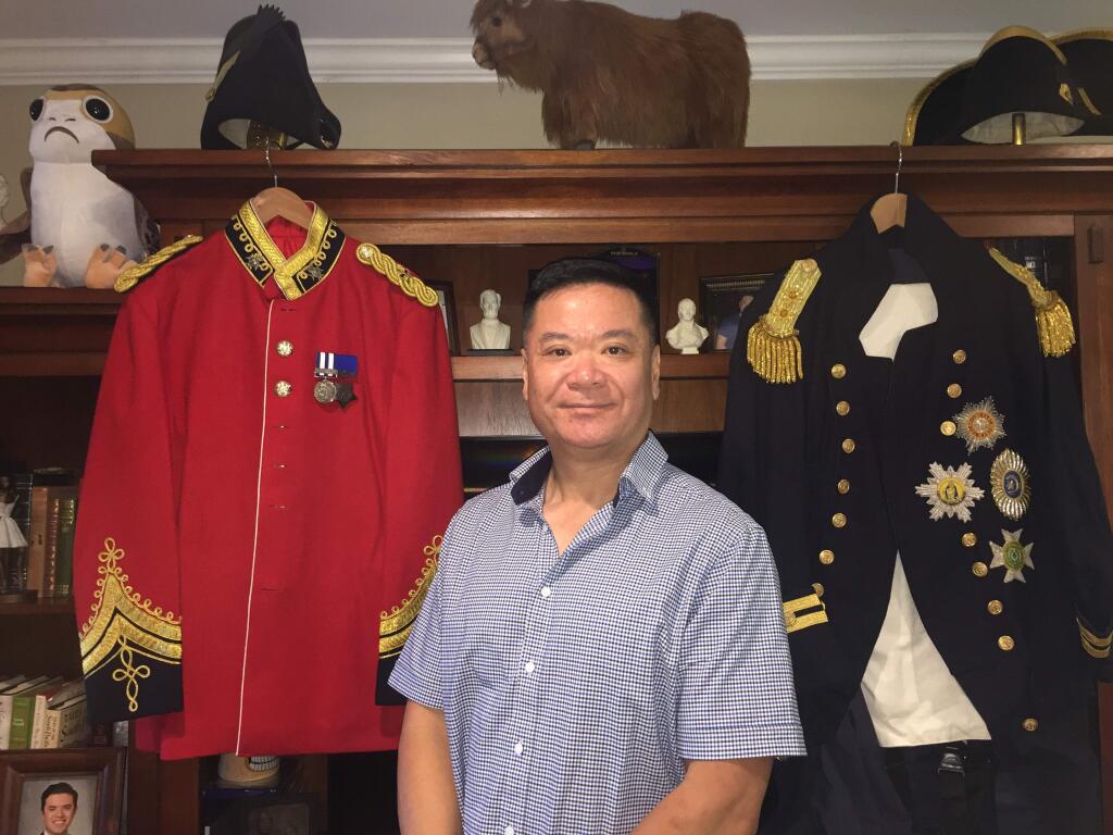 Petaluma's Ron Lam, with a few of the many uniforms in his collection. (PHOTO BY ARLINE KLATTE)