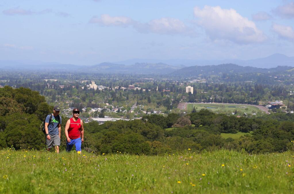 Jimmy Puujee, left, and Lkhagvasuren Erdeneulzii hike through Taylor Mountain Regional and Open Space Preserve, overlooking Santa Rosa, on Thursday, April 20, 2017. (Christopher Chung/ The Press Democrat)