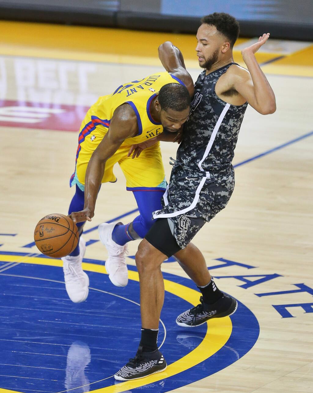 Golden State Warriors forward Kevin Durant is fouled by San Antonio Spurs' Kyle Anderson during their game in Oakland on Thursday, March 8, 2018. (Christopher Chung/ The Press Democrat)