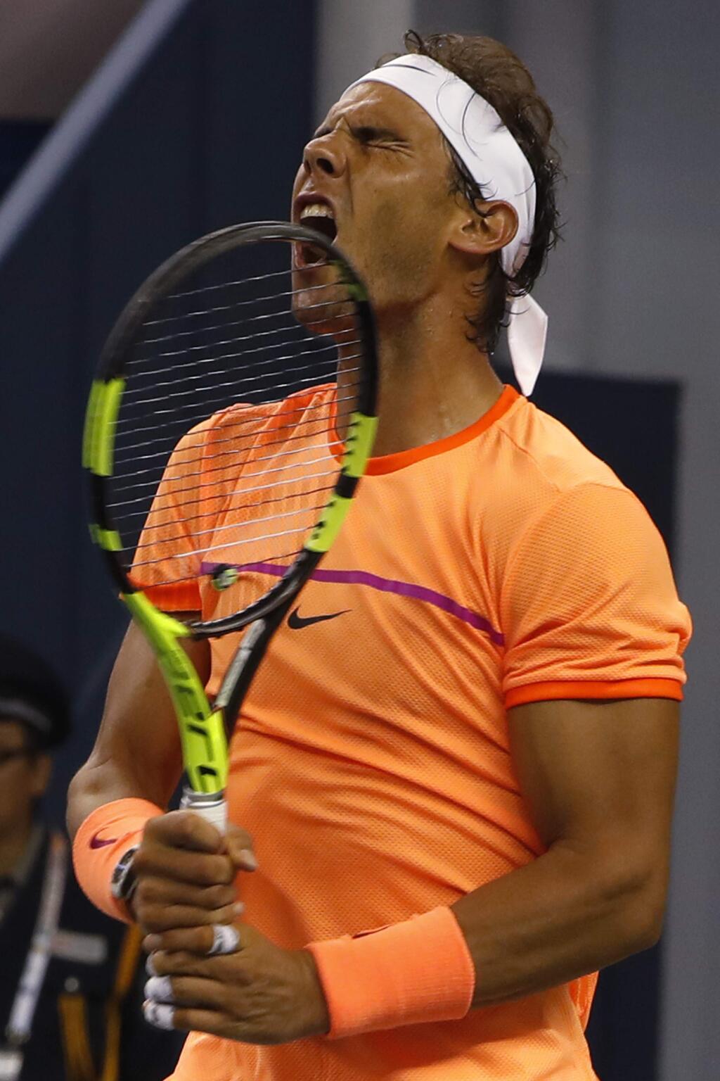 Rafael Nadal of Spain reacts after losing a point to Viktor Troicki of Serbia during the men's singles match of the Shanghai Masters tennis tournament at Qizhong Forest Sports City Tennis Center in Shanghai, China, Wednesday, Oct. 12, 2016. (AP Photo/Andy Wong)