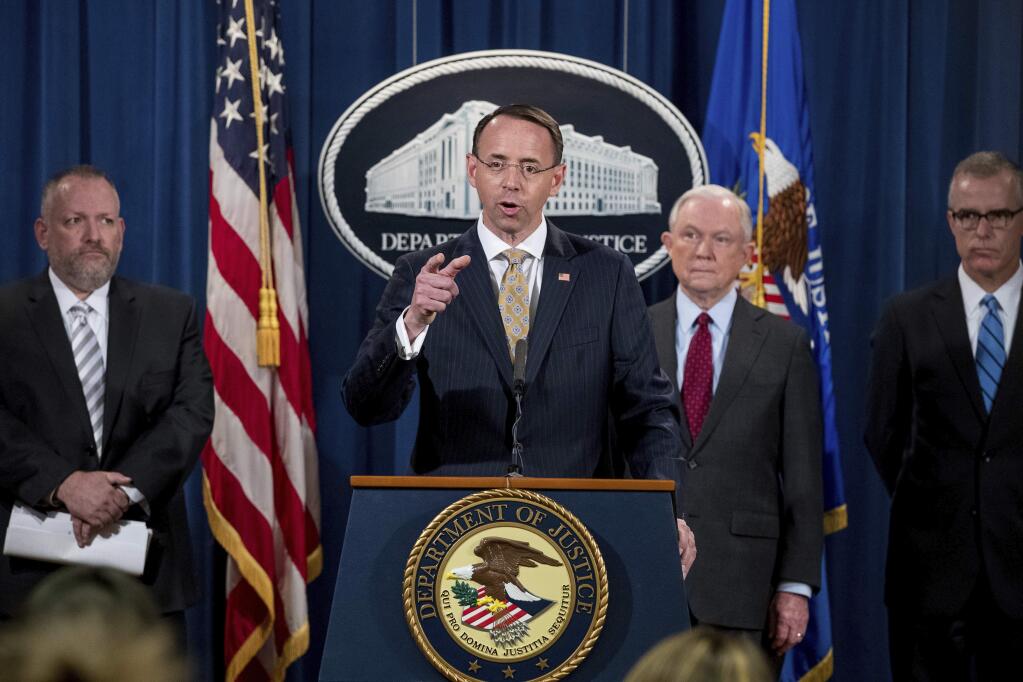 Deputy Attorney General Rod Rosenstein, center, accompanied by DEA Deputy Administrator Robert Patterson, left, Attorney General Jeff Sessions, second from right, and FBI Acting Director Andrew McCabe, right, speaks at a news conference to announce an international cybercrime enforcement action at the Department of Justice, Thursday, July 20, 2017, in Washington. (AP Photo/Andrew Harnik)