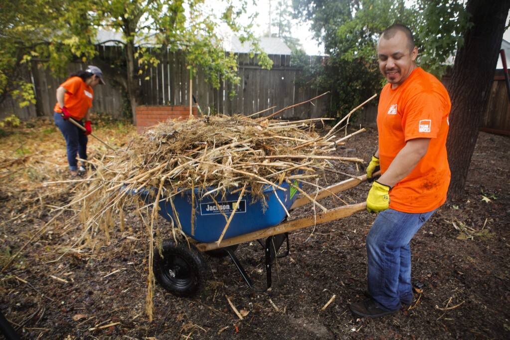 Petaluma, CA, USA. Friday, October 14, 2016._ Miguel Estrada of Fairfield was one of dozens of volunteers from North Bay area Home Depots who helped clean and repair the east Petaluma home of WWII veteran, Albert Pericou,90. (CRISSY PASCUAL/ARGUS-COURIER STAFF)