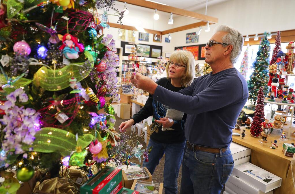 Denelle and Gary Tognozzi of Sebastopol shop for Christmas ornaments at Corrick's in downtown Santa Rosa. (CHRISTOPHER CHUNG / The Press Democrat)