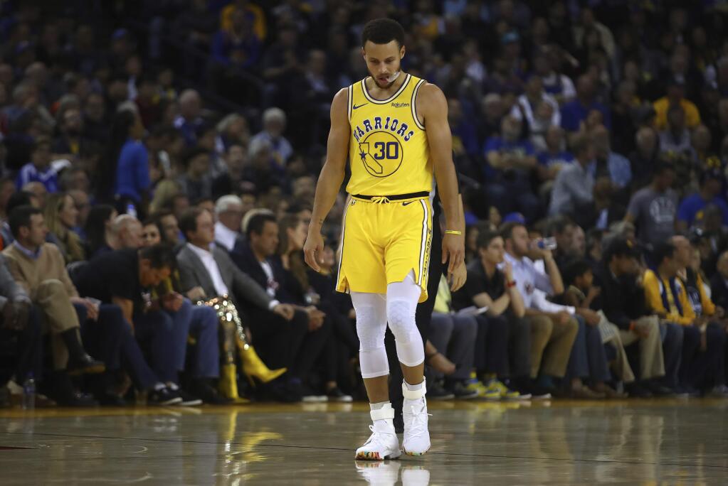 The Golden State Warriors' Stephen Curry walks on the court during a timeout in the second half against the Milwaukee Bucks on Thursday, Nov. 8, 2018, in Oakland. (AP Photo/Ben Margot)
